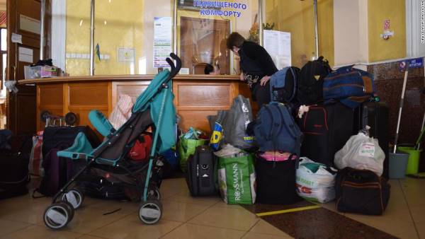 Baby strollers, diapers and formula line the entryway of the room for women and children above Lviv station